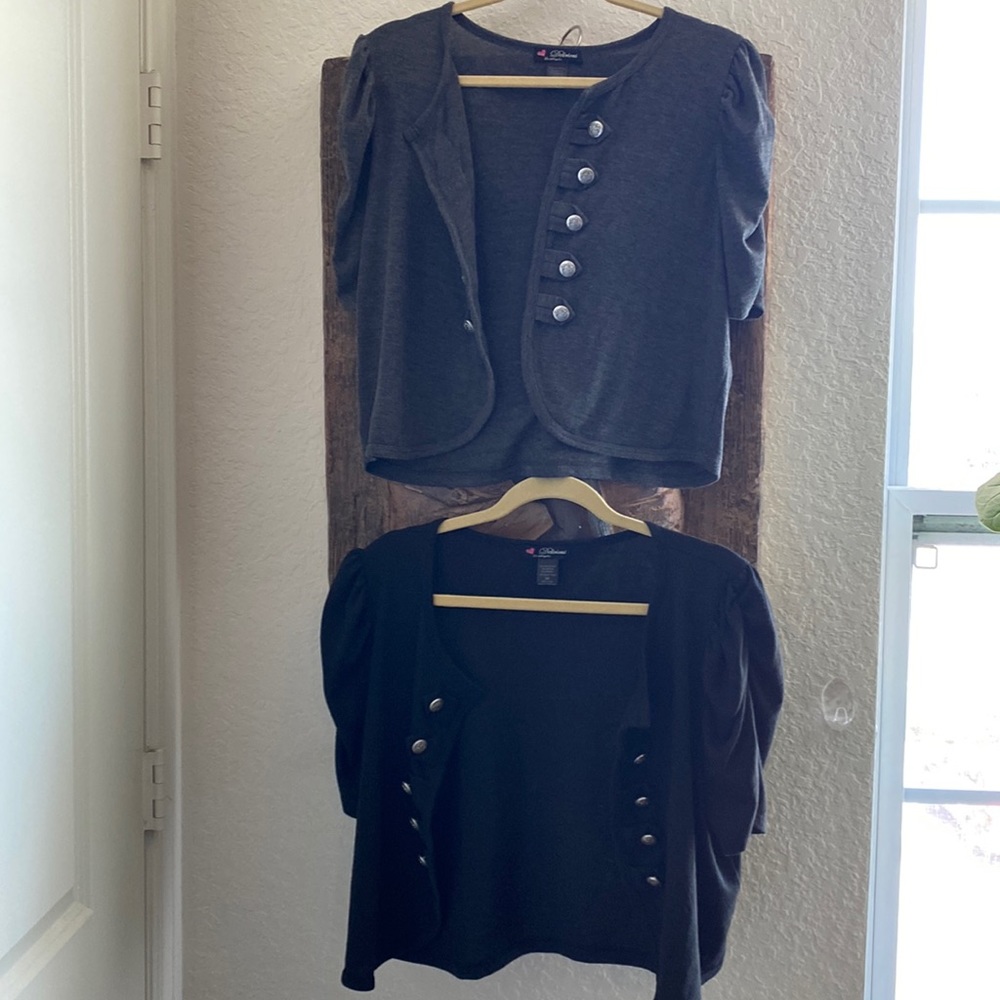 1 black and 1 grey vest. Silver buttons on both(they do not button close).